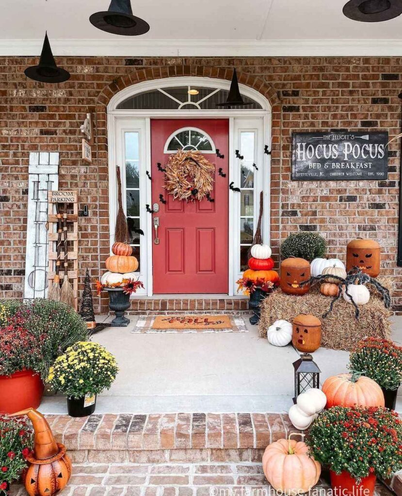 Halloween porch, pumpkins, witches' hats, mums