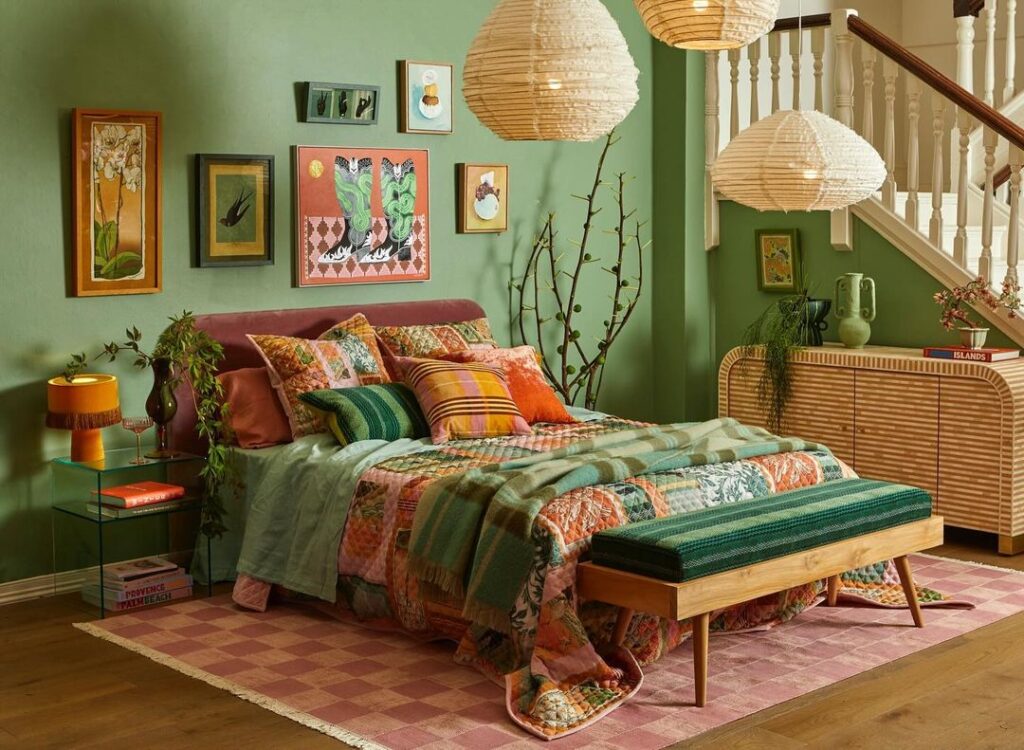 Green boho bedroom with colorful bedding, artwork