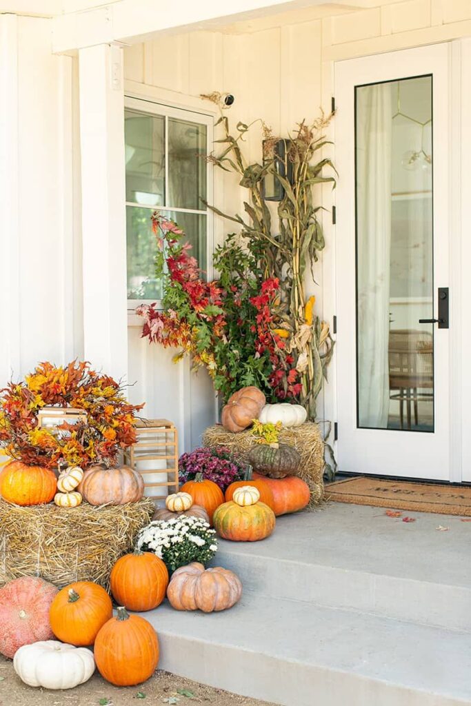 Porch with pumpkins, hay, fall flowers