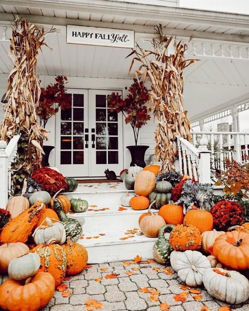 Pumpkin-filled porch, corn stalks, autumn abundance