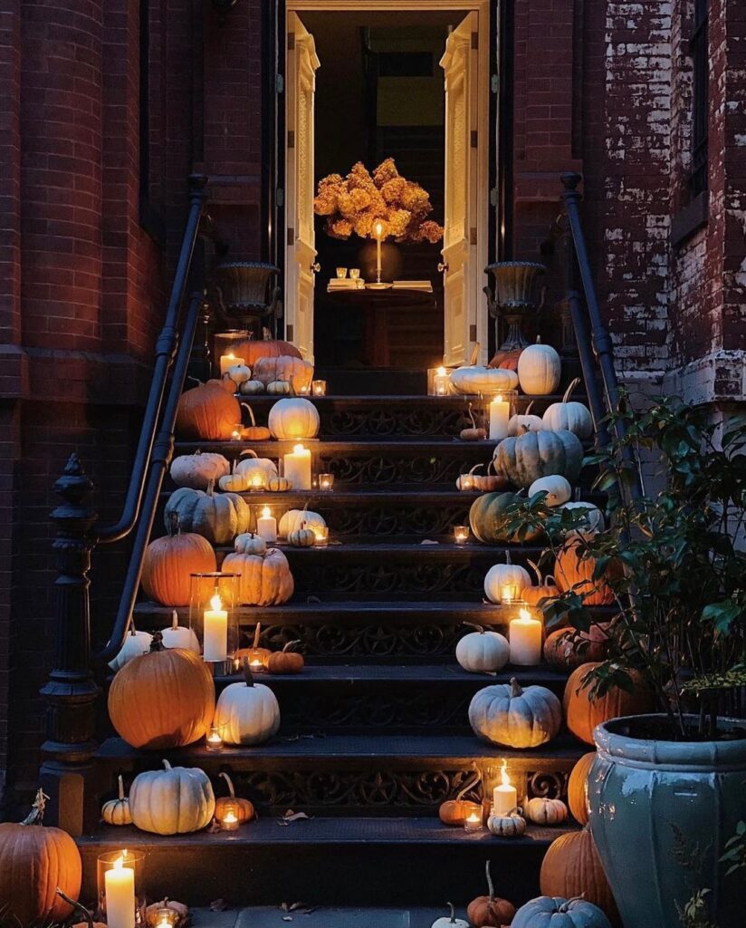 Candlelit stairway decorated with various pumpkins