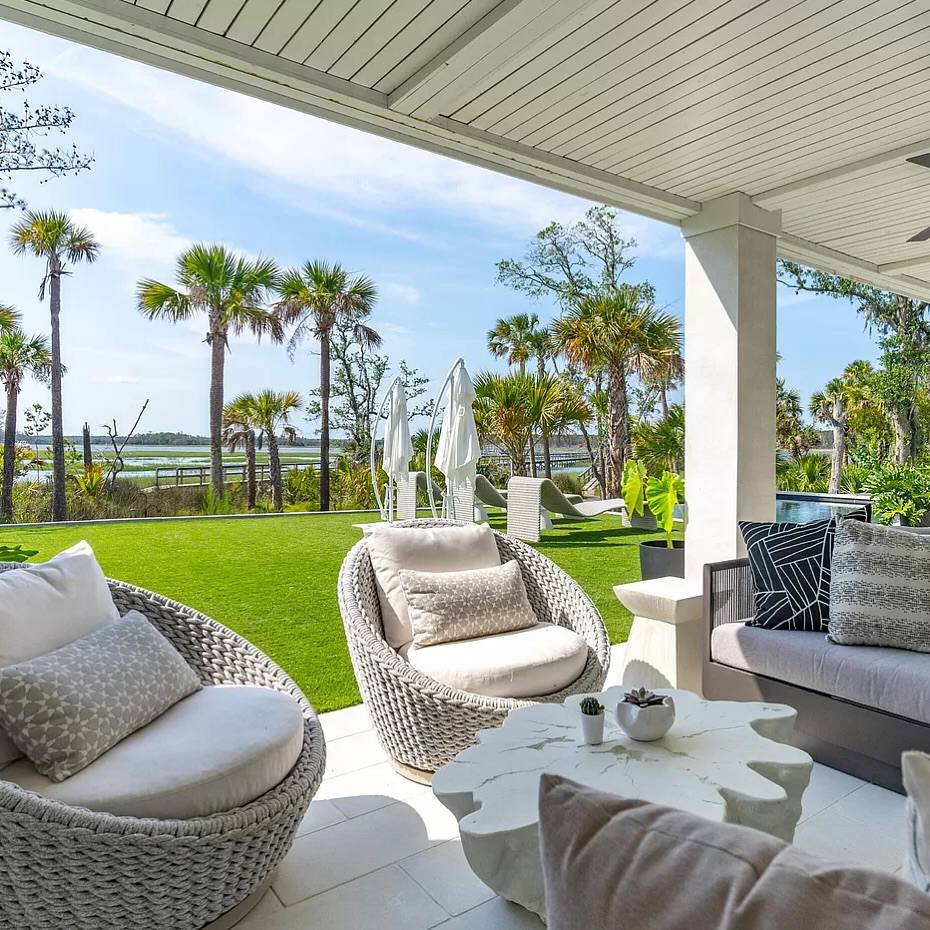 Beachfront porch with woven furniture and palms