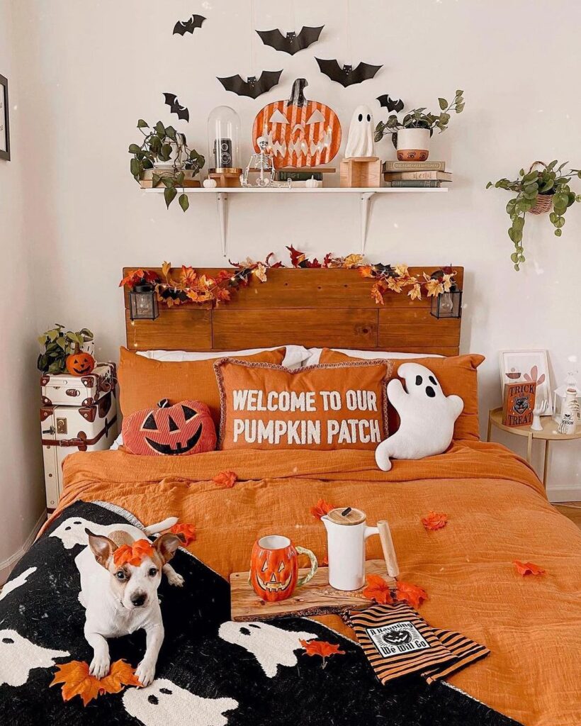 Halloween-themed bedroom with orange decor and dog