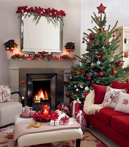 Living room with red Christmas decor fireplace and tree