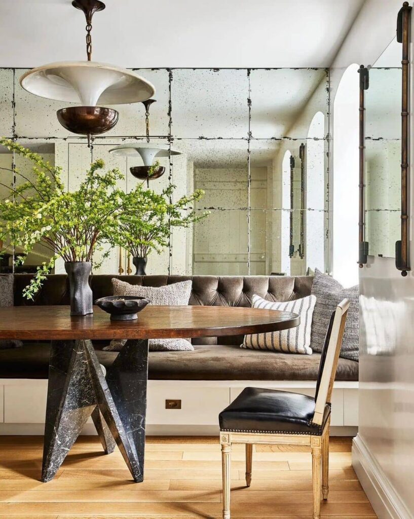 Rustic-modern lobby, mirrors, unique table, greenery