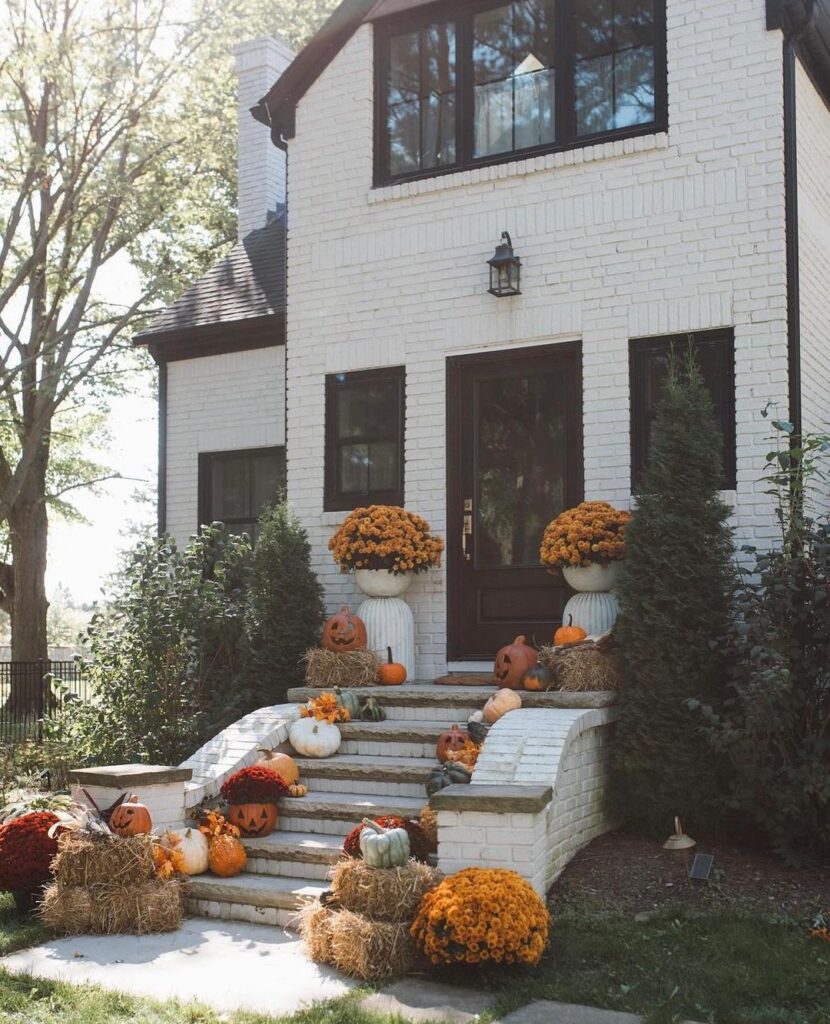 White house, pumpkin-decorated steps, mums, fall decor