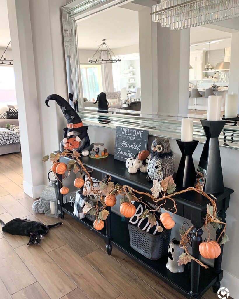 Halloween entryway decor with pumpkins and witchy accents