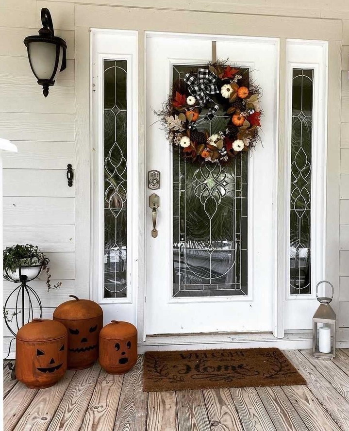 Halloween porch, wreath, pumpkin buckets, elegant door