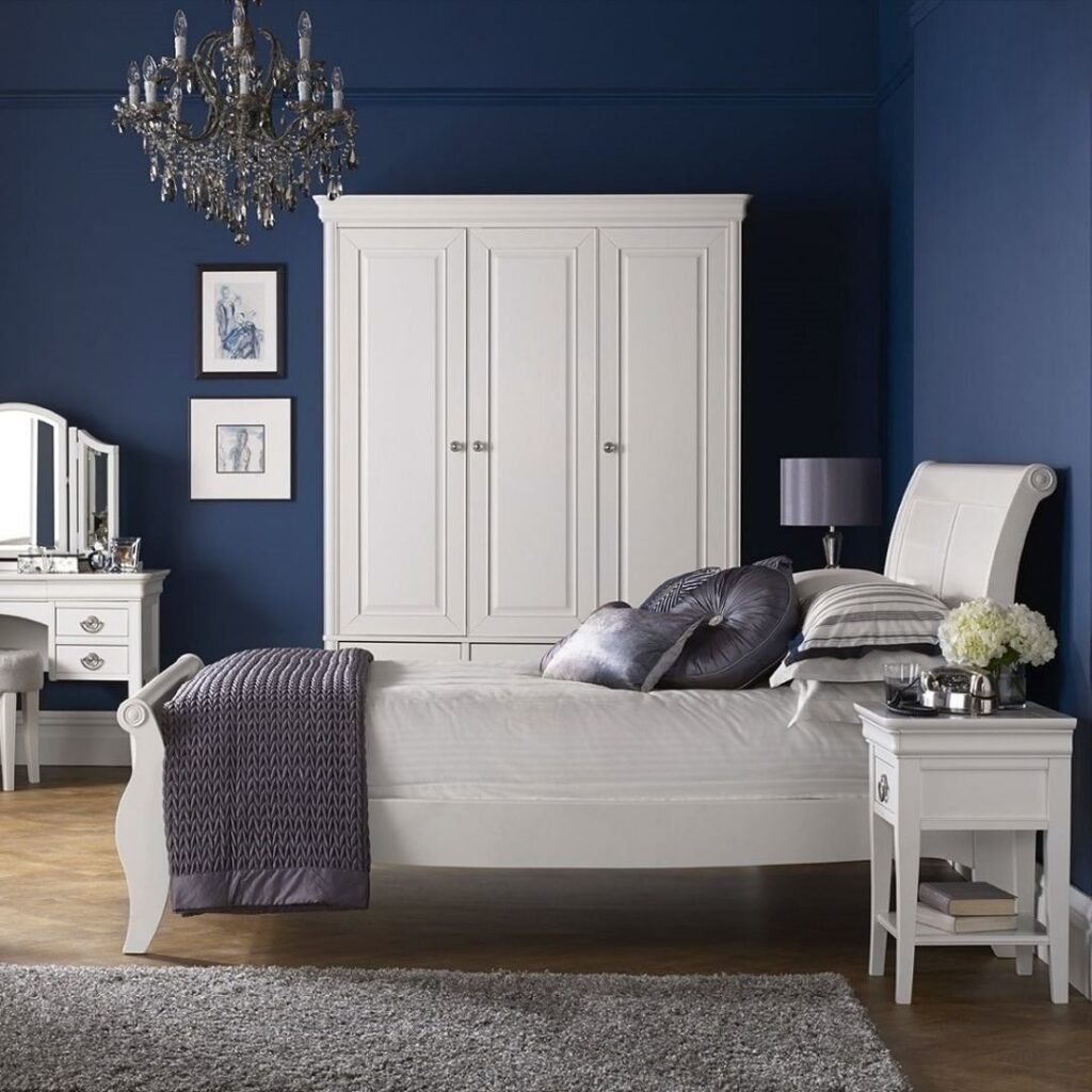 Navy bedroom with white furniture accents