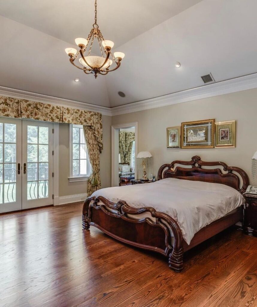 Traditional bedroom with ornate dark wood bed