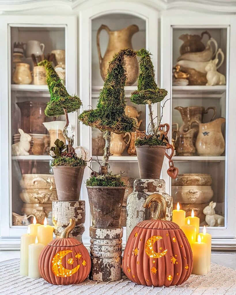 Mossy witch hats and glowing pumpkins display