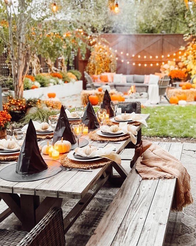 Halloween outdoor table, pumpkins, string lights