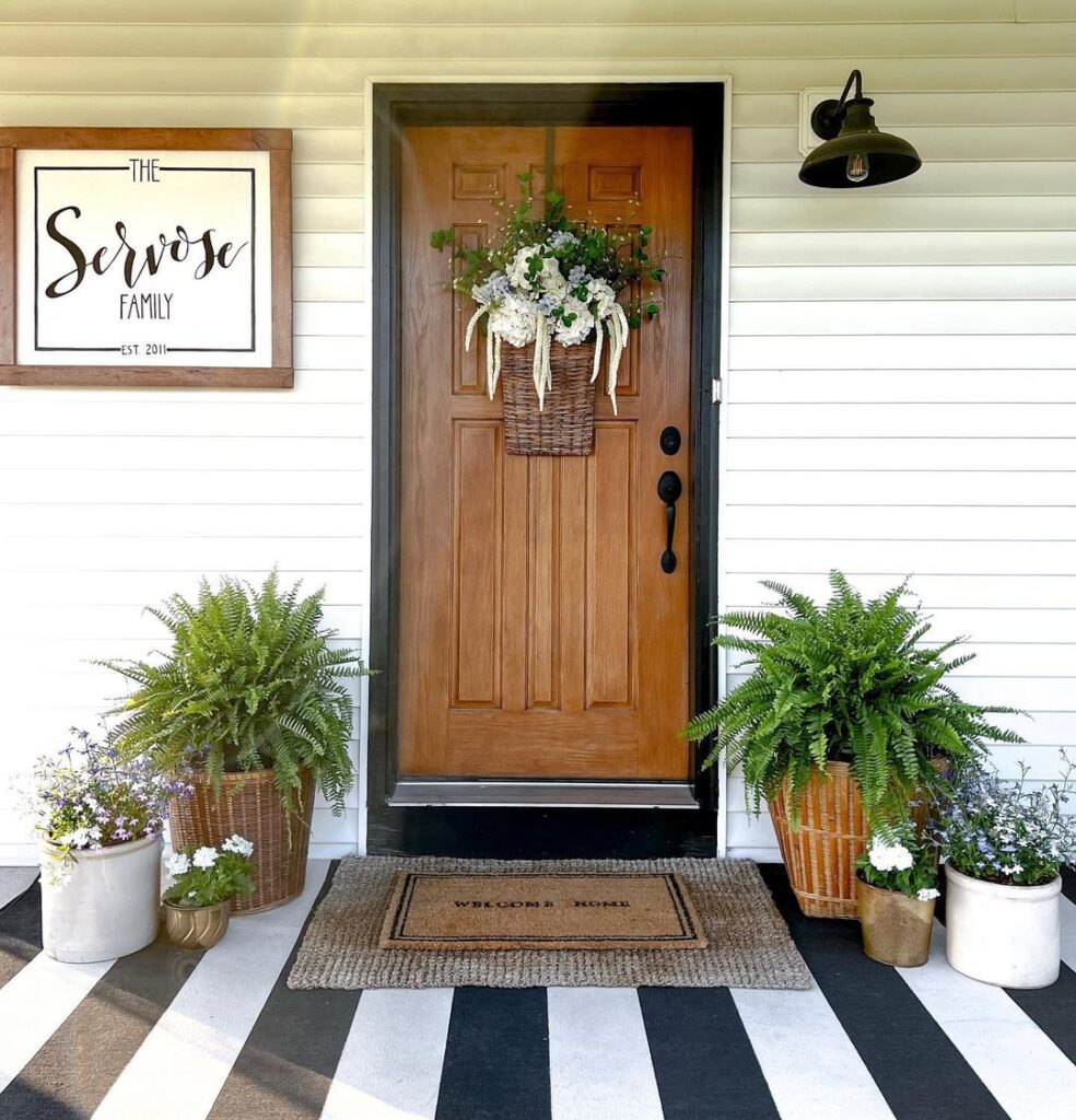 Farmhouse porch wooden door ferns striped floor