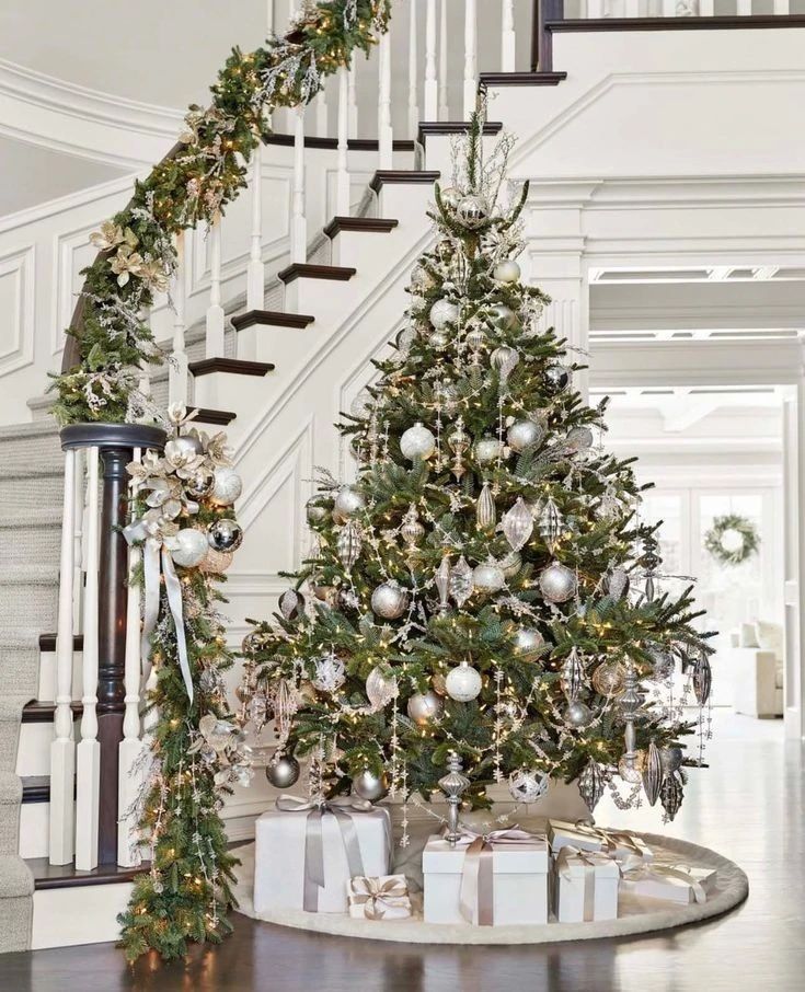 Silver-decorated Christmas tree and staircase garland