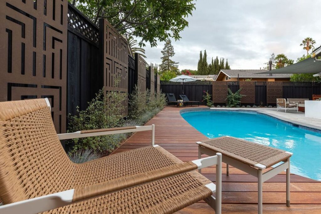 Modern poolside with geometric privacy fence