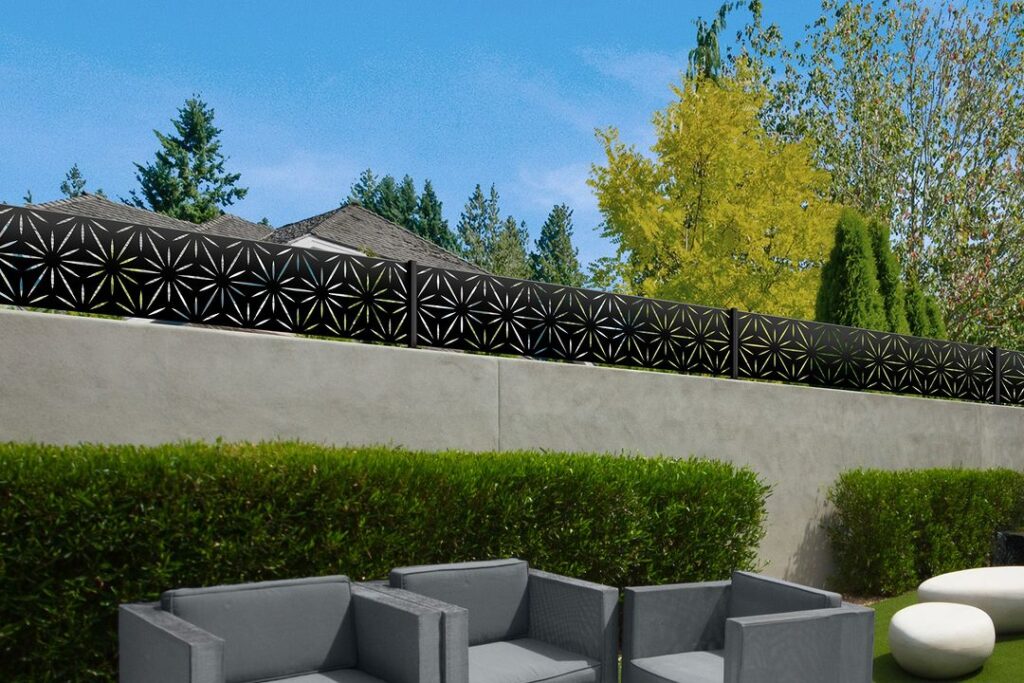 Concrete wall with decorative metal fence topper