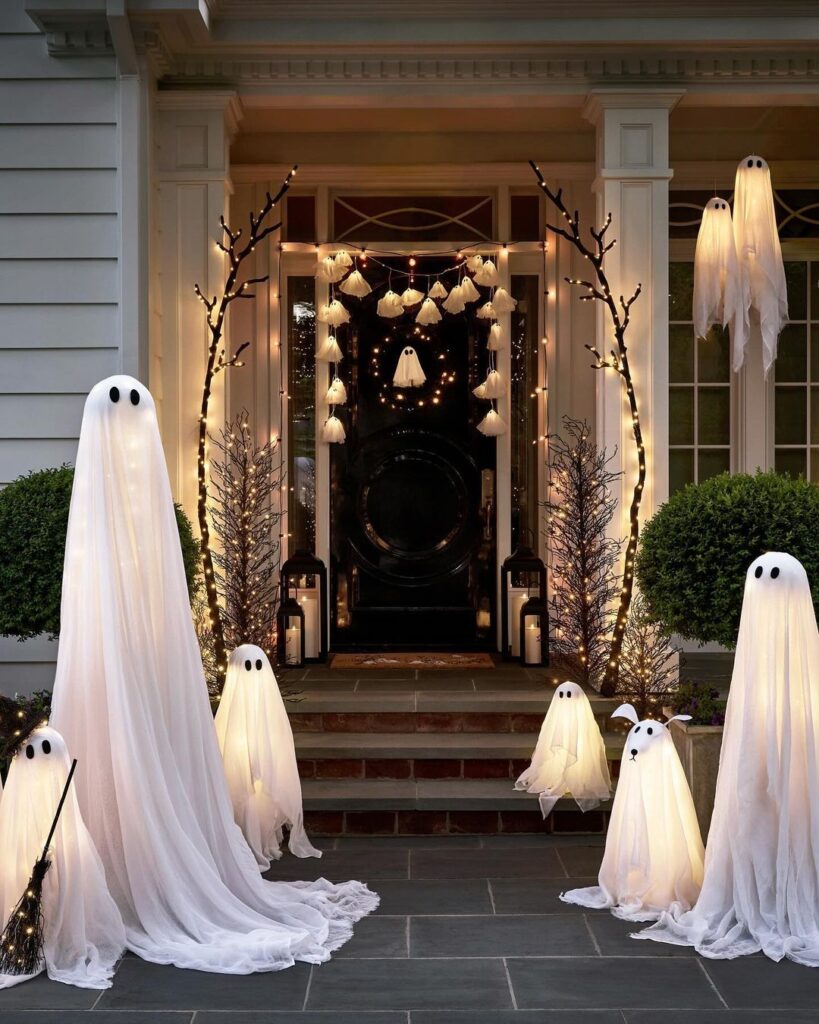 Illuminated ghosts and lights on Halloween porch