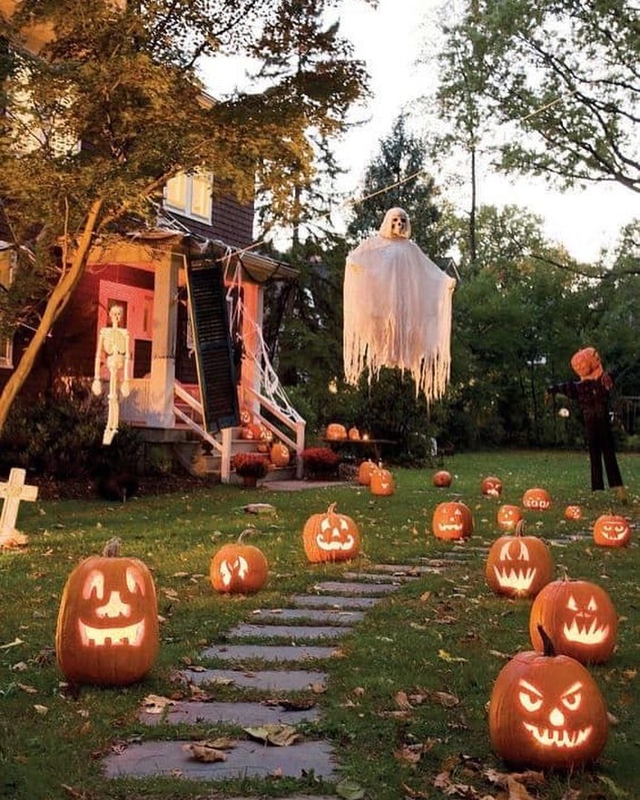 Pumpkin-lined path, floating ghost, decorated house