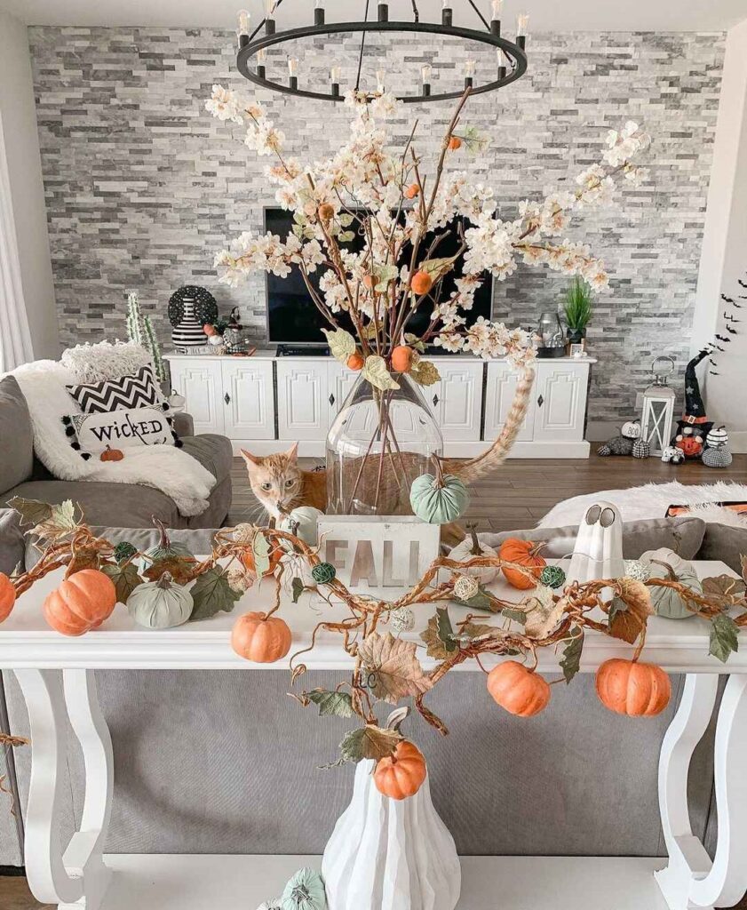 Fall-decorated living room with pumpkins and cat