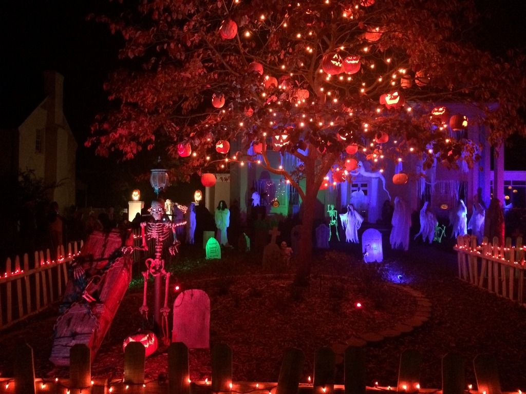 Halloween yard with lit pumpkin tree and ghosts