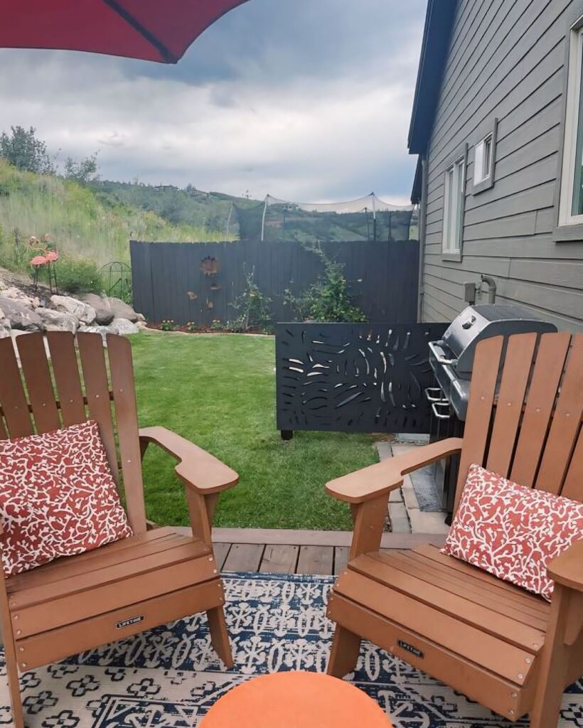 Backyard deck chairs privacy fence hillside