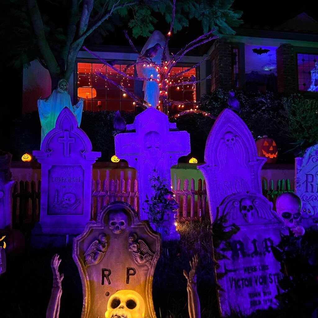 Purple-lit Halloween graveyard with glowing tombstones

