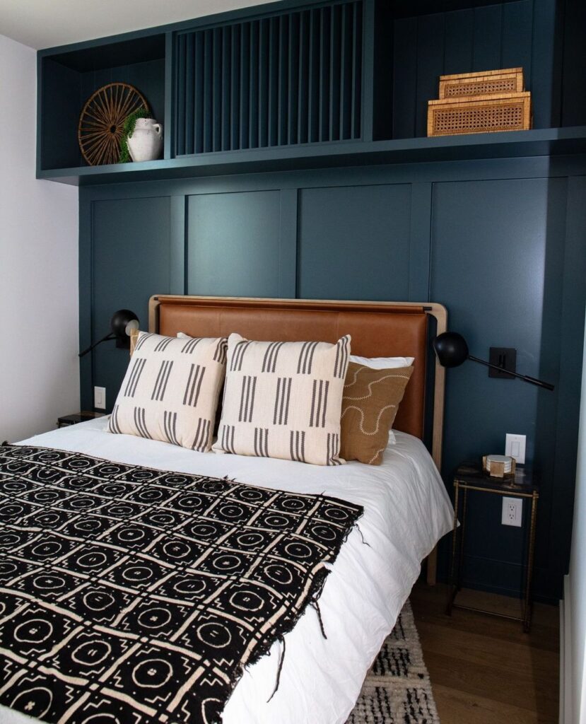 Blue bedroom with leather headboard, geometric bedding