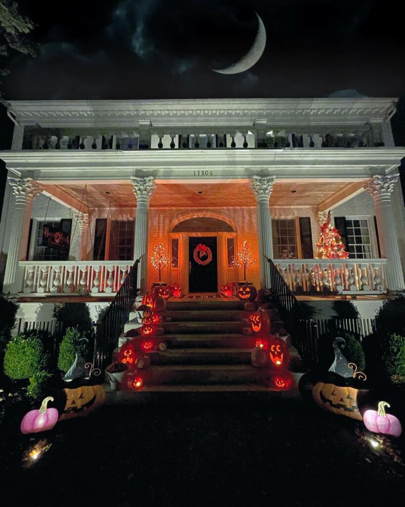 Mansion with lit pumpkins and crescent moon