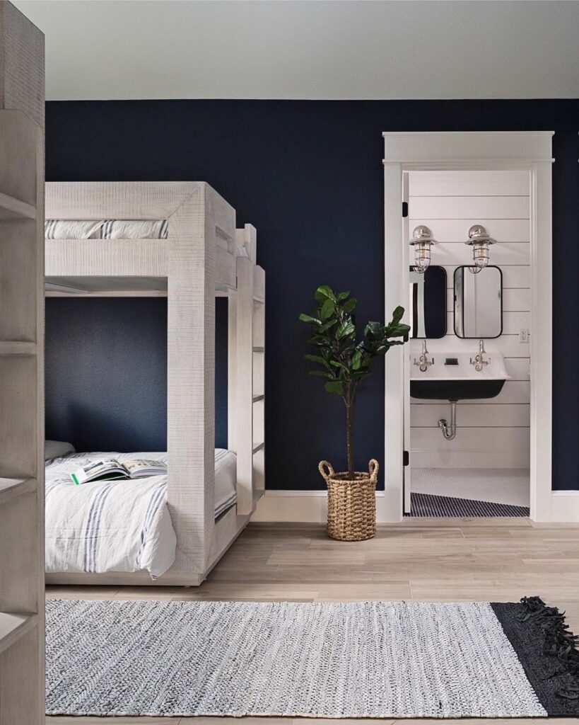 Navy bedroom, white bunk bed, bathroom