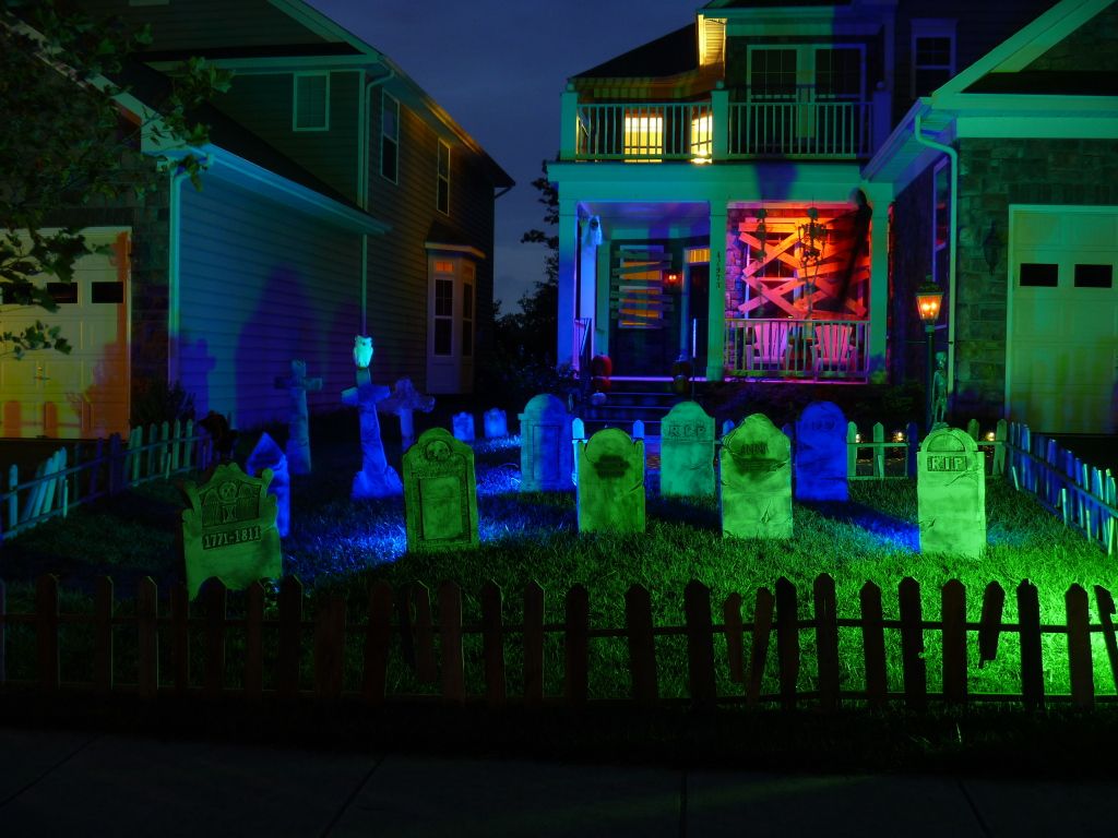 Neon-lit Halloween graveyard in front yard