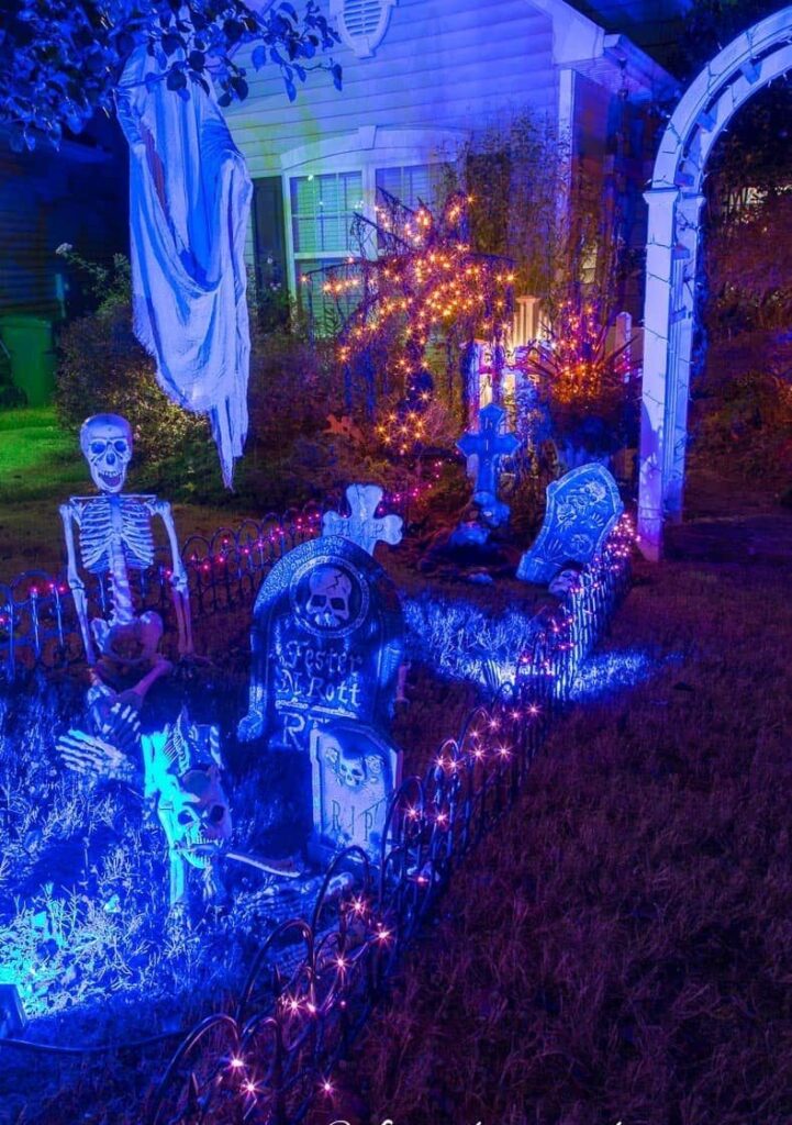 Blue-lit Halloween graveyard with skeletons