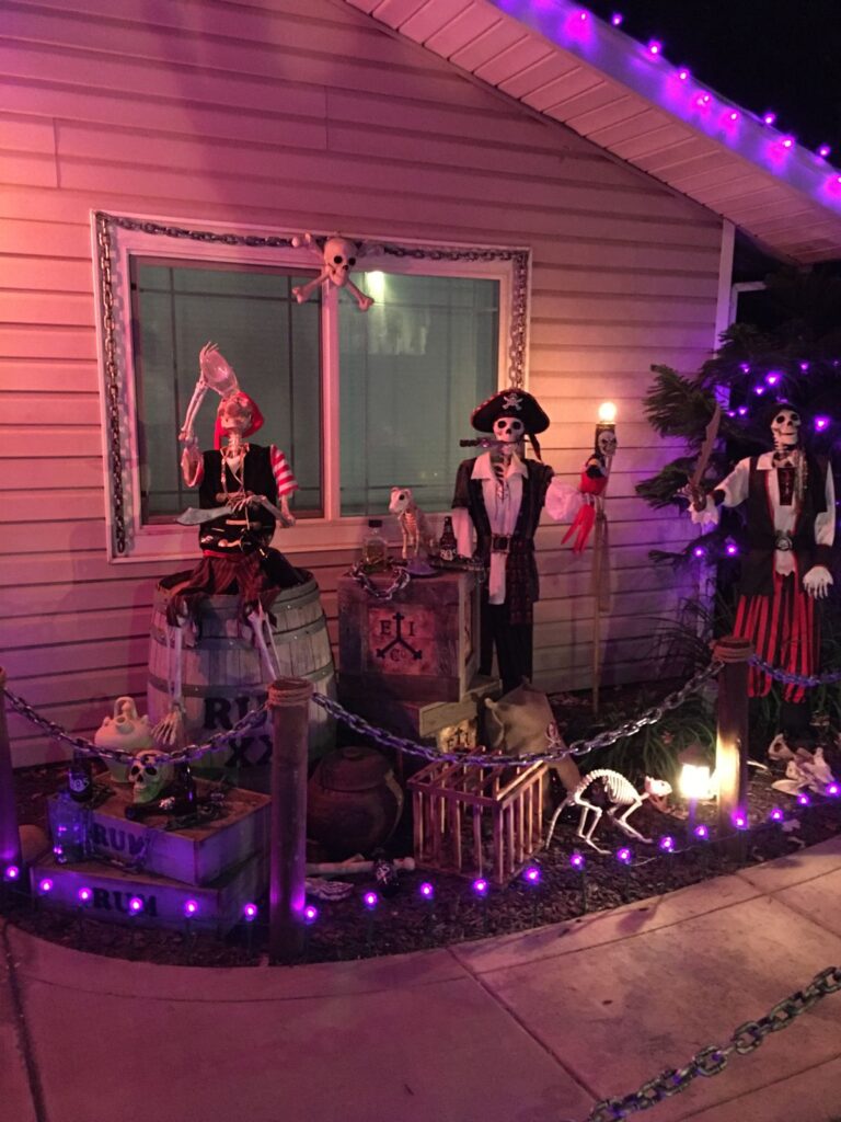 Halloween pirate-themed display with skeleton decorations and purple lights