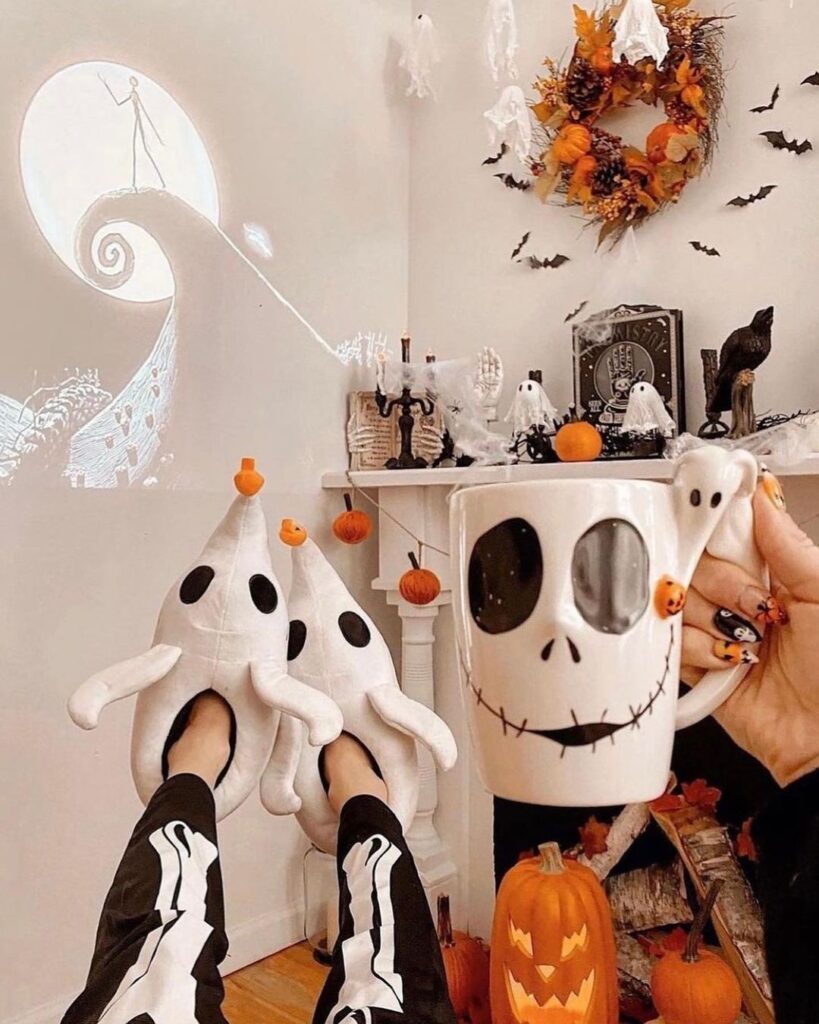 Halloween decor with ghost slippers and Jack Skellington mug