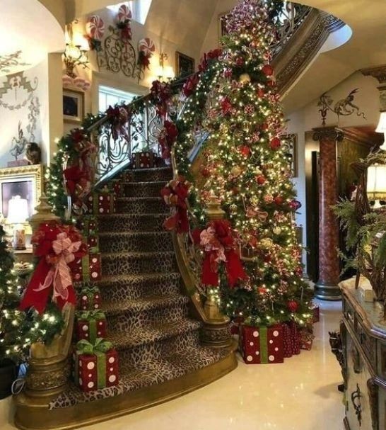 Lavishly decorated spiral staircase with Christmas tree