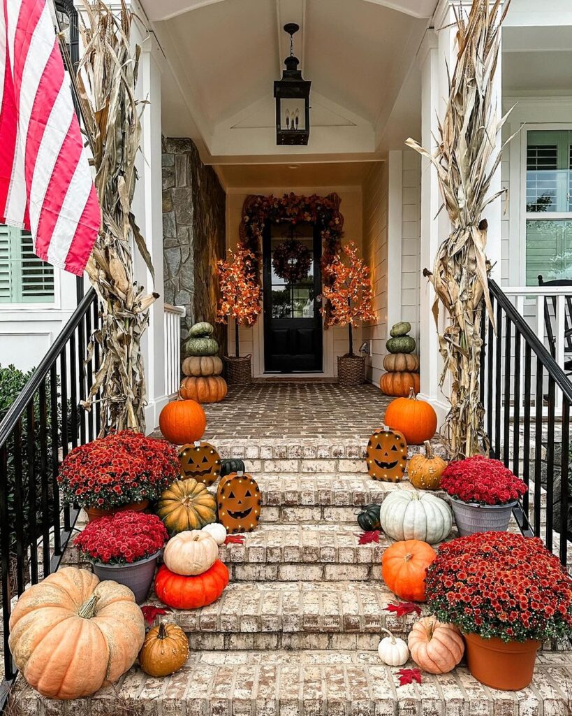 Porch with flag, pumpkins, mums, cornstalks