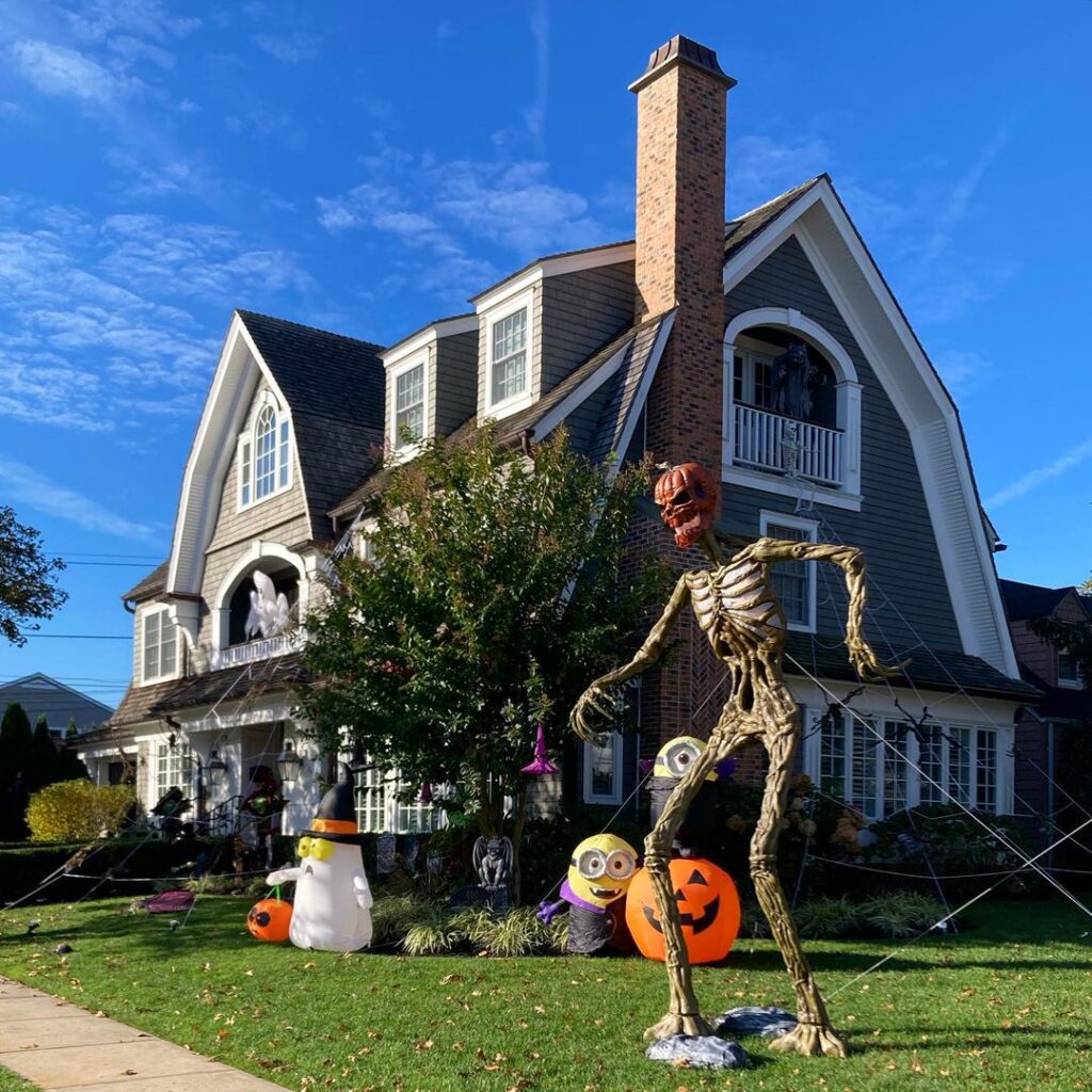 House with giant skeleton and Halloween inflatables