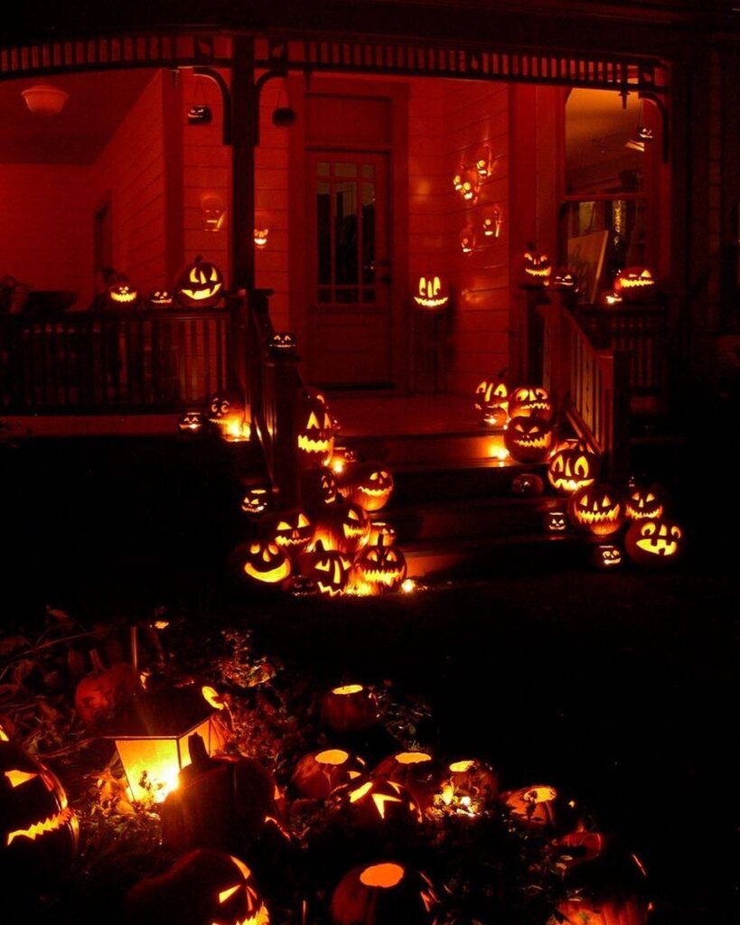 Glowing jack-o'-lanterns covering porch, steps