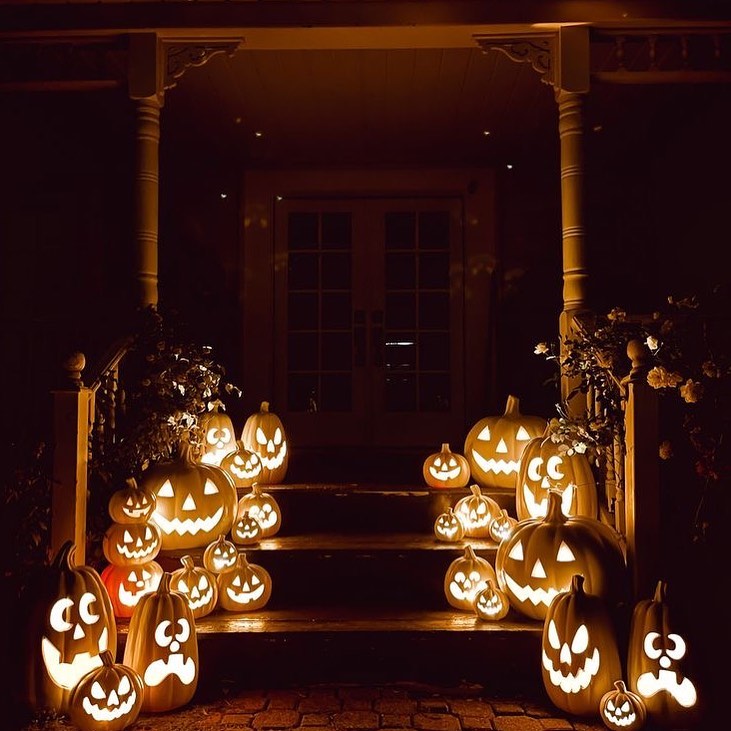 Lit jack-o'-lanterns on porch steps