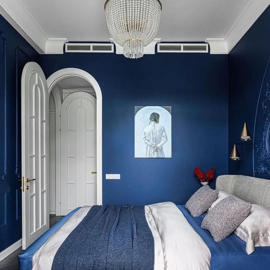 Elegant navy blue bedroom with crystal chandelier