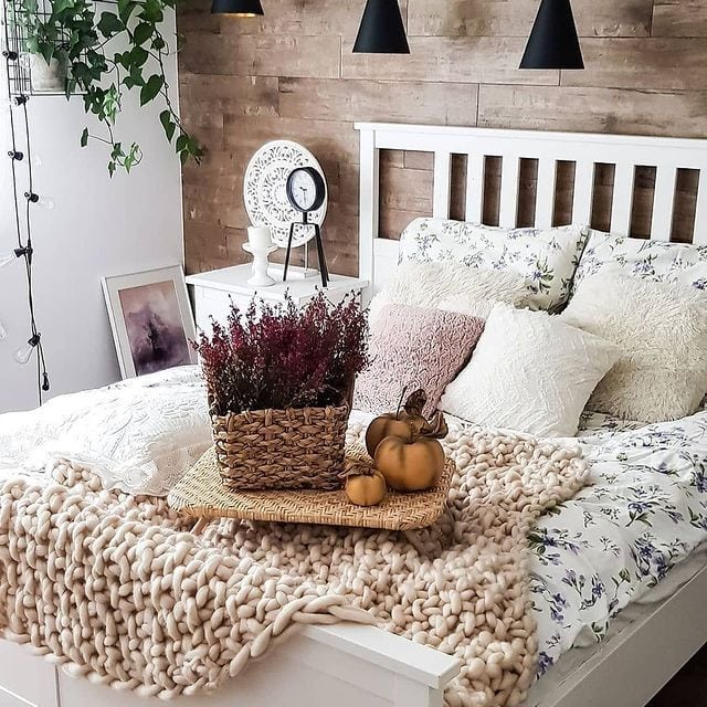 Cozy bedroom with fall decor, knit throw