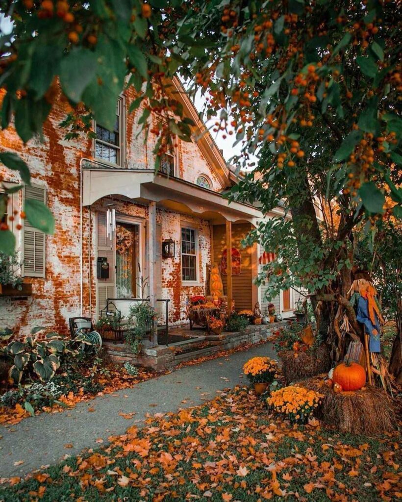 Brick cottage porch decorated for autumn