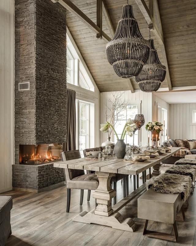 Rustic dining room with fireplace and chandeliers