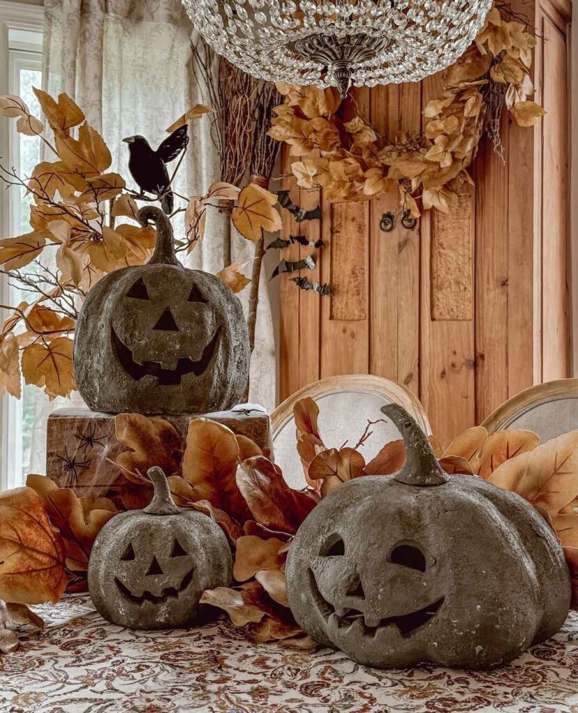 Concrete pumpkins with fall leaves and chandelier