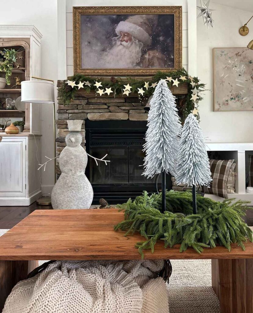 Christmas mantel with star garland and Santa painting