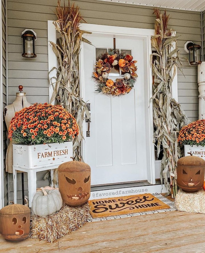 Farmhouse porch, mums, cornstalks, pumpkins