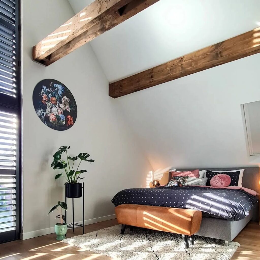 Bedroom with beams and floral art