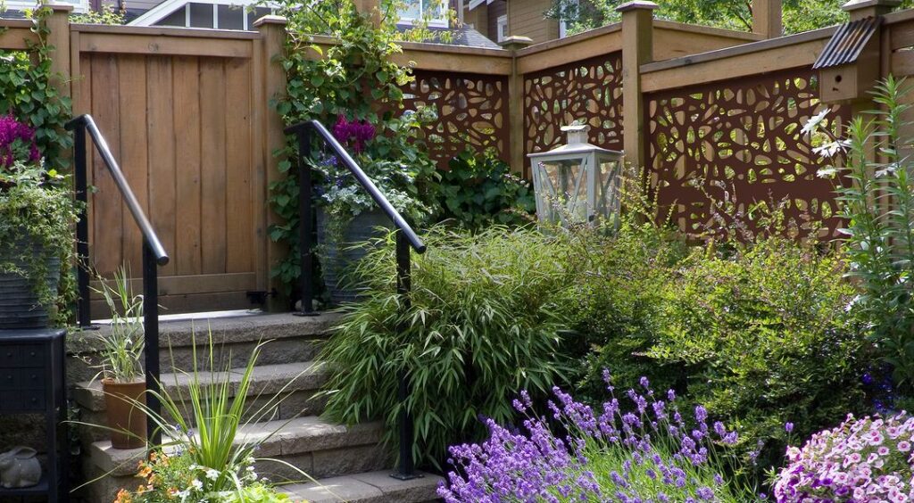 Garden entrance with wooden fence and flowers