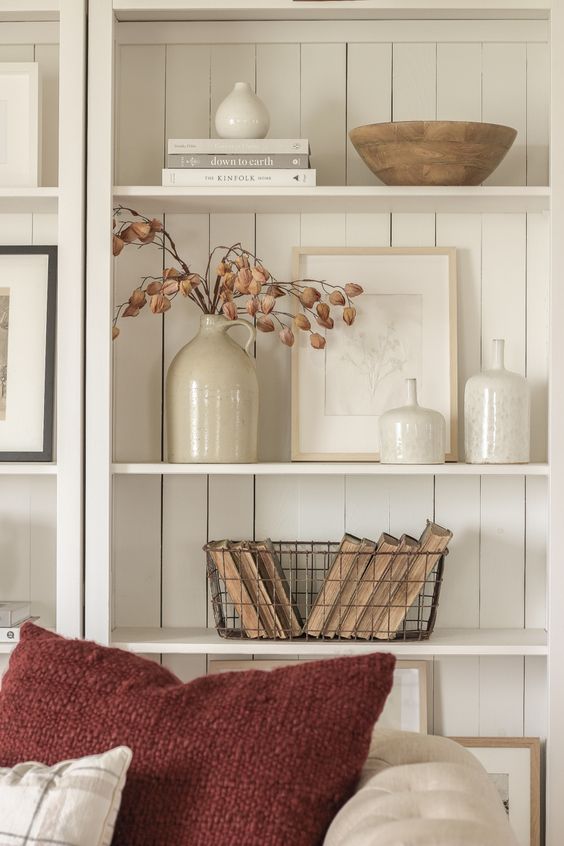 Neutral shelves, dried branches, vintage books, autumn textures