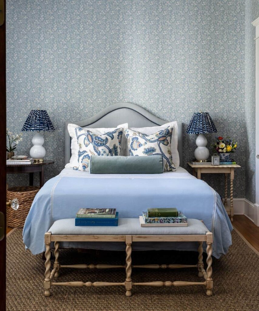 Blue floral wallpaper, cottage-style bed, mismatched decor