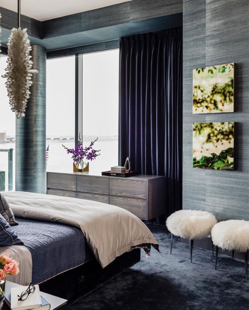 Blue-gray bedroom with city view window